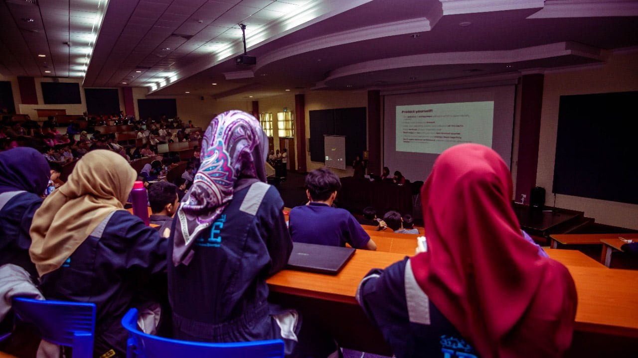A group of students learning inside a lecture hall.