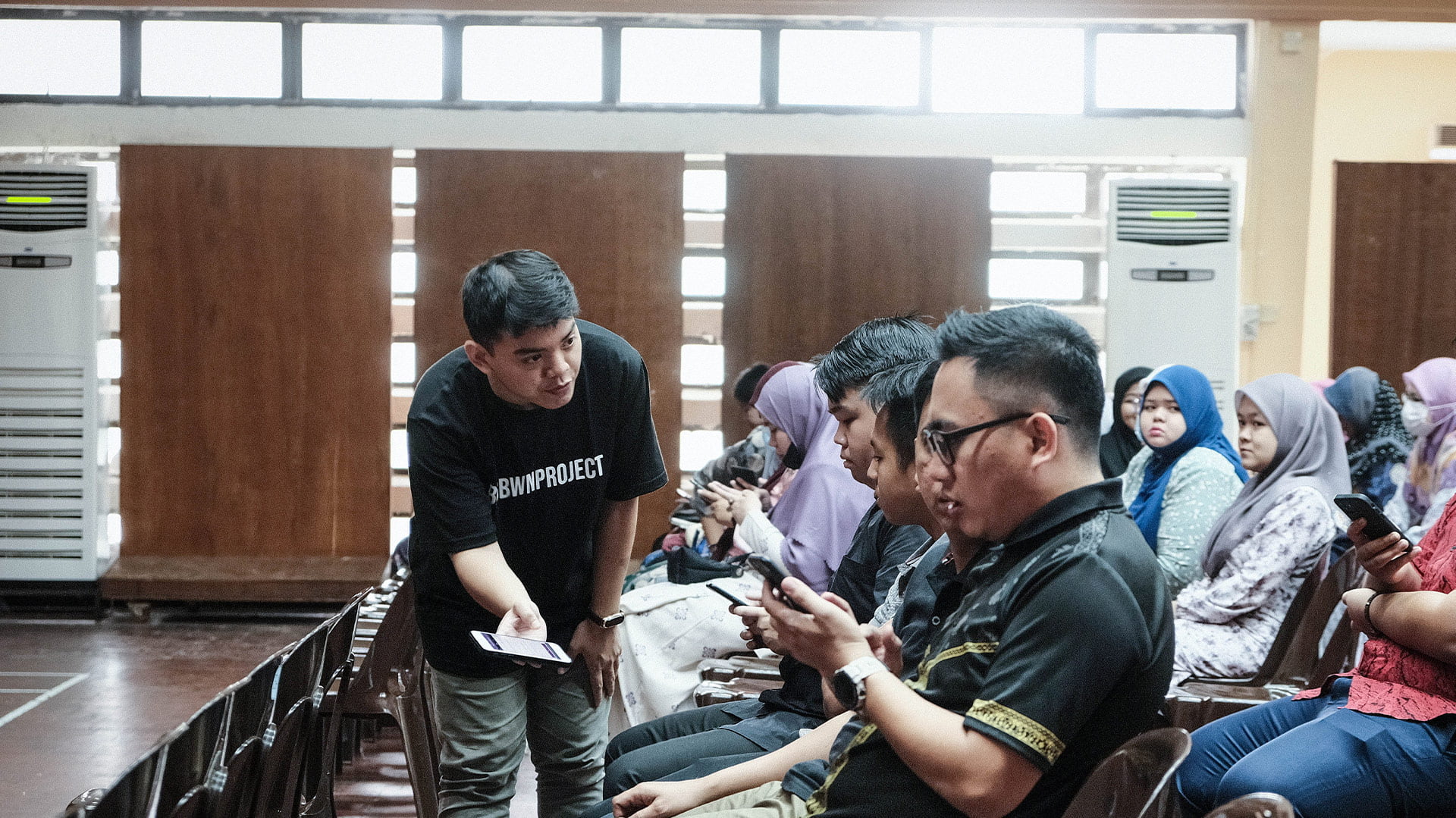 Teaching Asean trainees how to use smartphones.